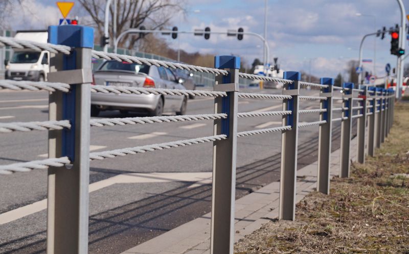 Cable barriers lined along the side of the road prevent traffic from veering off the road.