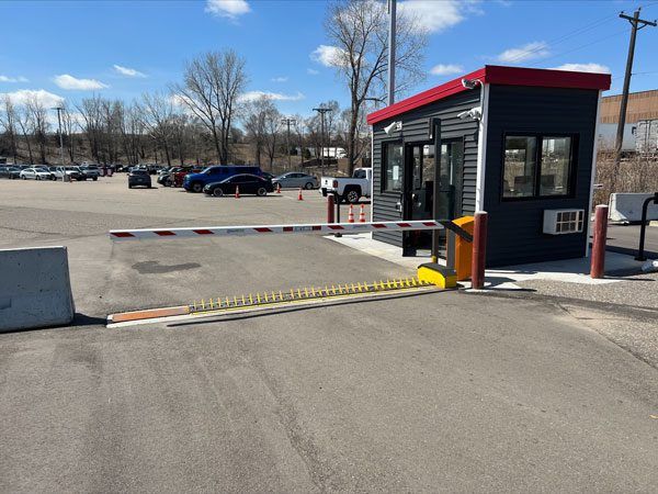 A Low Profile Electric Road Barrier blocks the exit of a parking lot in Minneapolis.