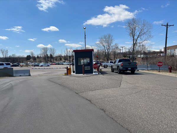 A Low Profile Electric Road Barrier blocks the exit of a parking lot in Minneapolis.