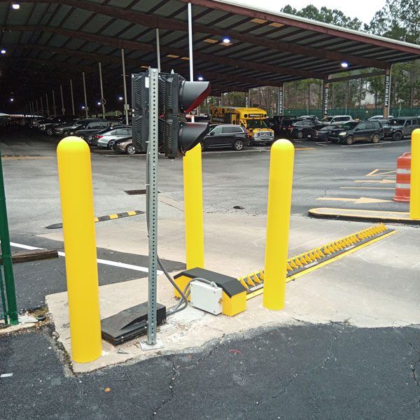 A Roadshark spiked barrier blocks the exit of a parking lot to help with traffic control.