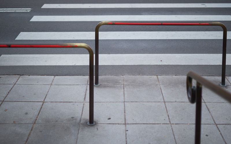 A pedestrian barrier stops people from wandering out onto a road.
